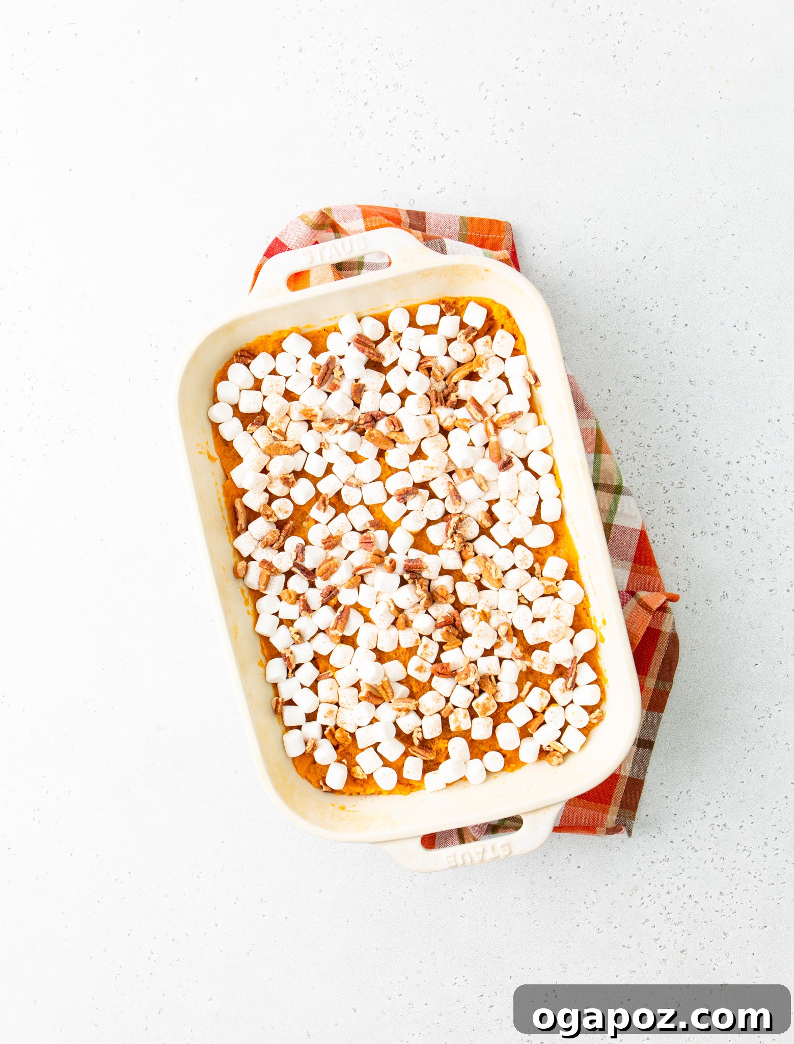 Golden Sweet Potato Marshmallow Delight 11 Sweet Potato Casserole with Marshmallows in a casserole dish, fresh out of the oven with golden-brown marshmallows
