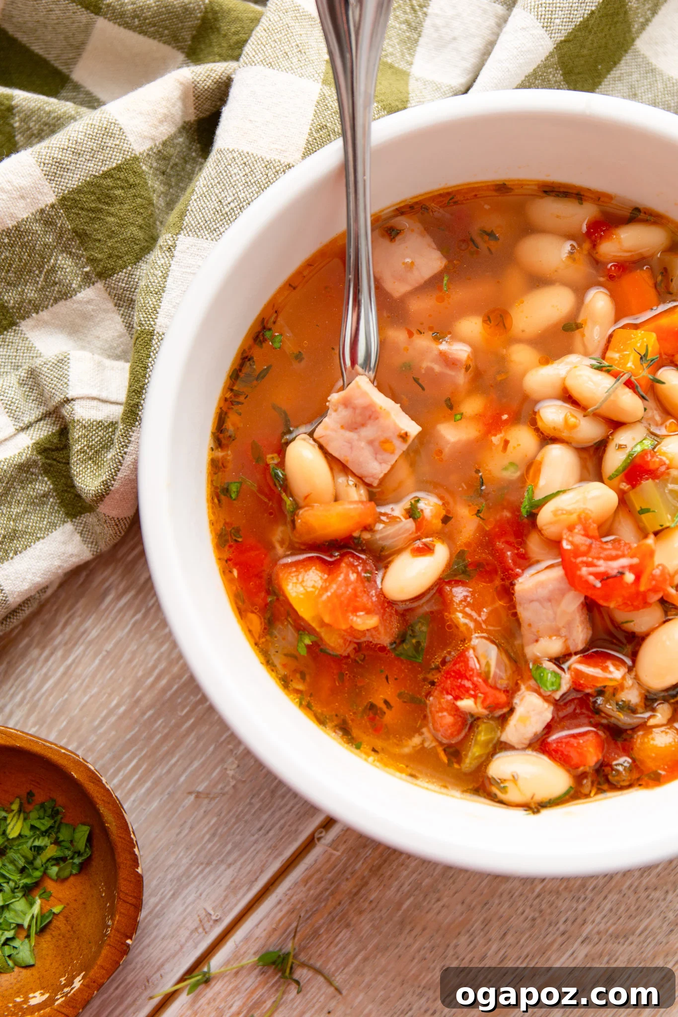 Hearty Navy Bean Soup 2 A bowl of classic Navy Bean Soup with a spoon and a napkin, showcasing its rich texture and inviting warmth.