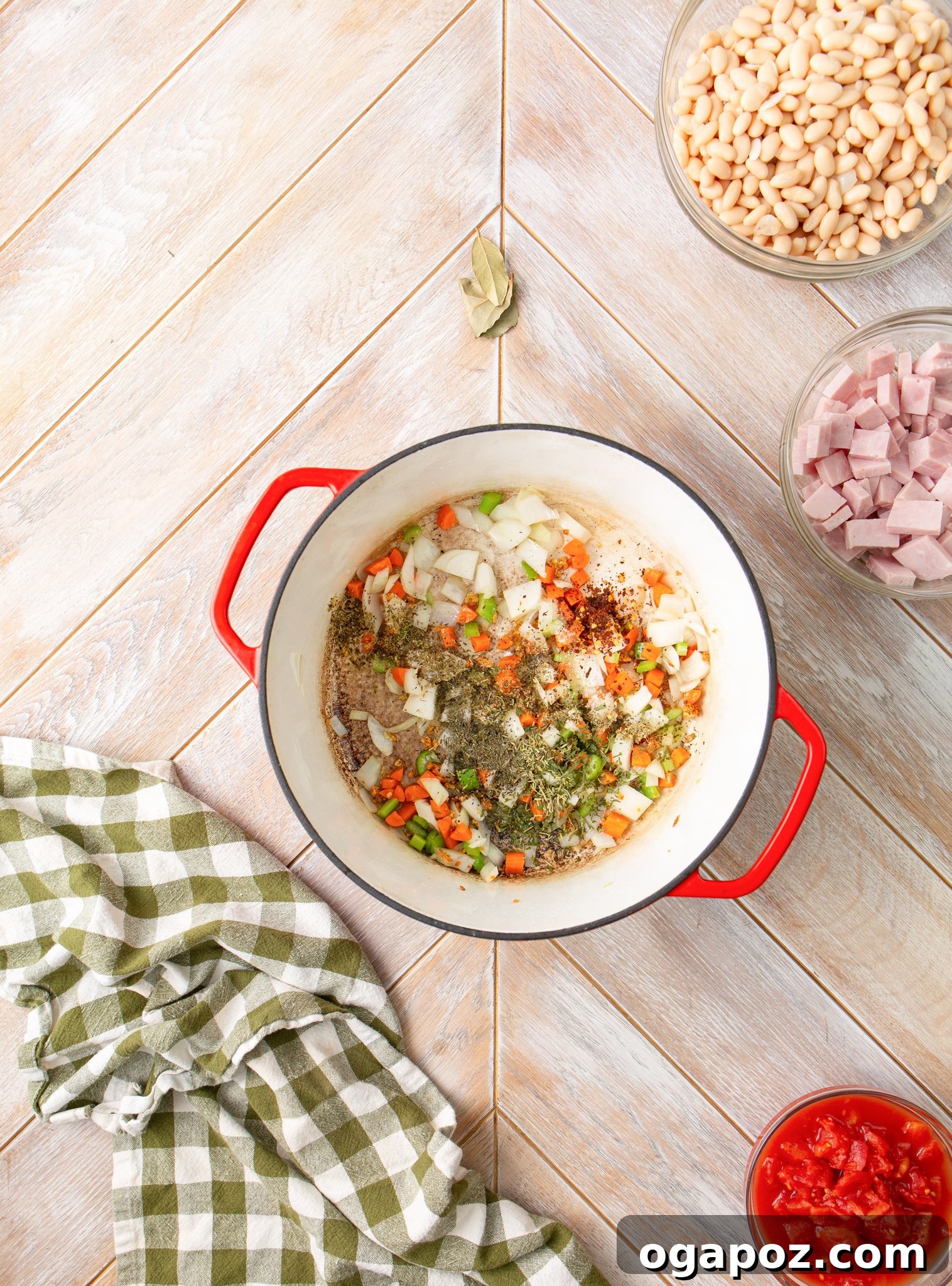 Hearty Navy Bean Soup 9 Dried herbs and spices mixed with sautéed vegetables in a pot, releasing their rich aromas.