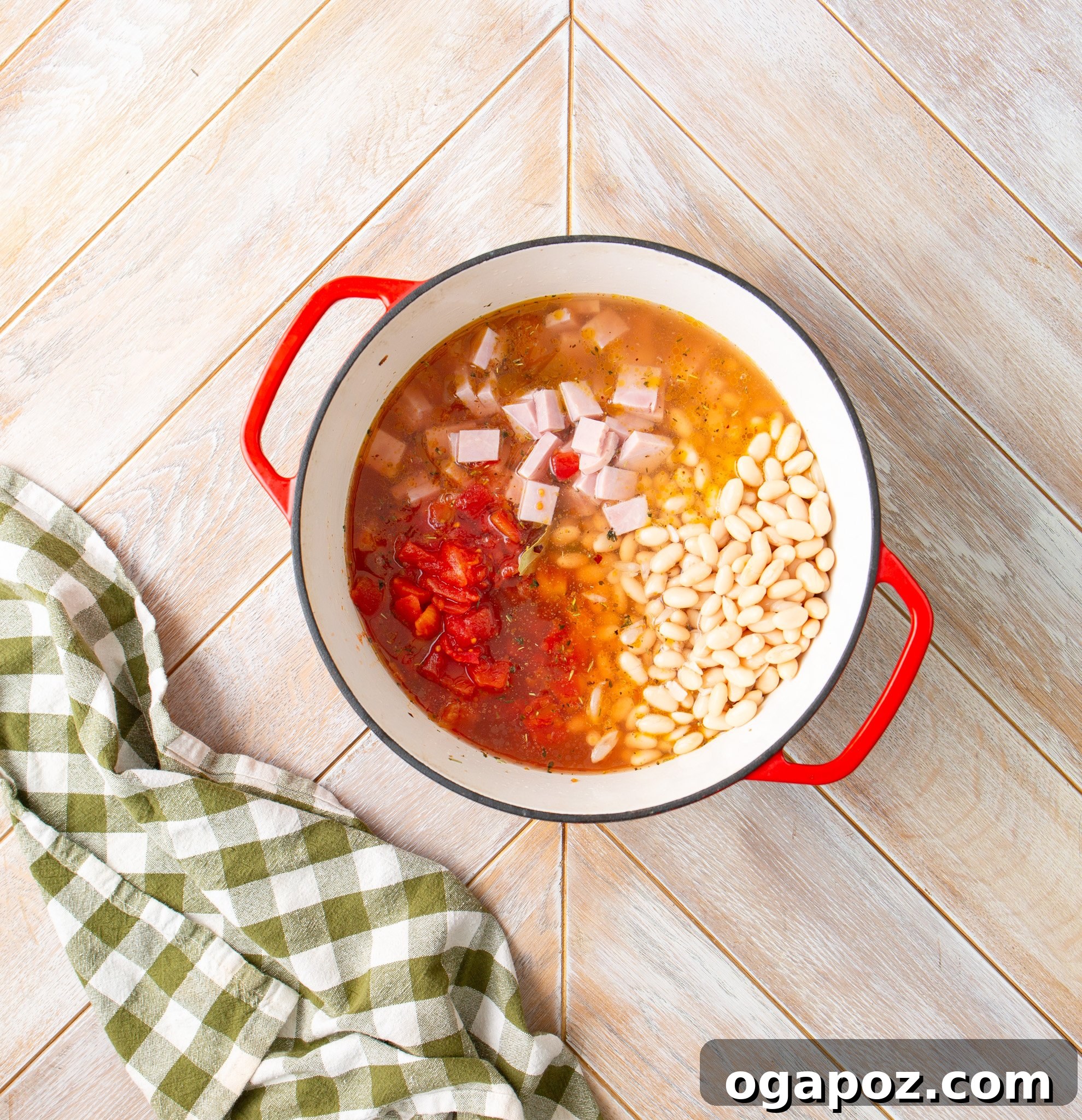 Hearty Navy Bean Soup 10 Diced tomatoes, ham, and beans added to the pot with the broth, ready for simmering.