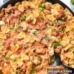 Irresistible Creamy Chicken Chorizo Pasta 9 Creamy Chicken and Chorizo Pasta in a skillet with a spoon