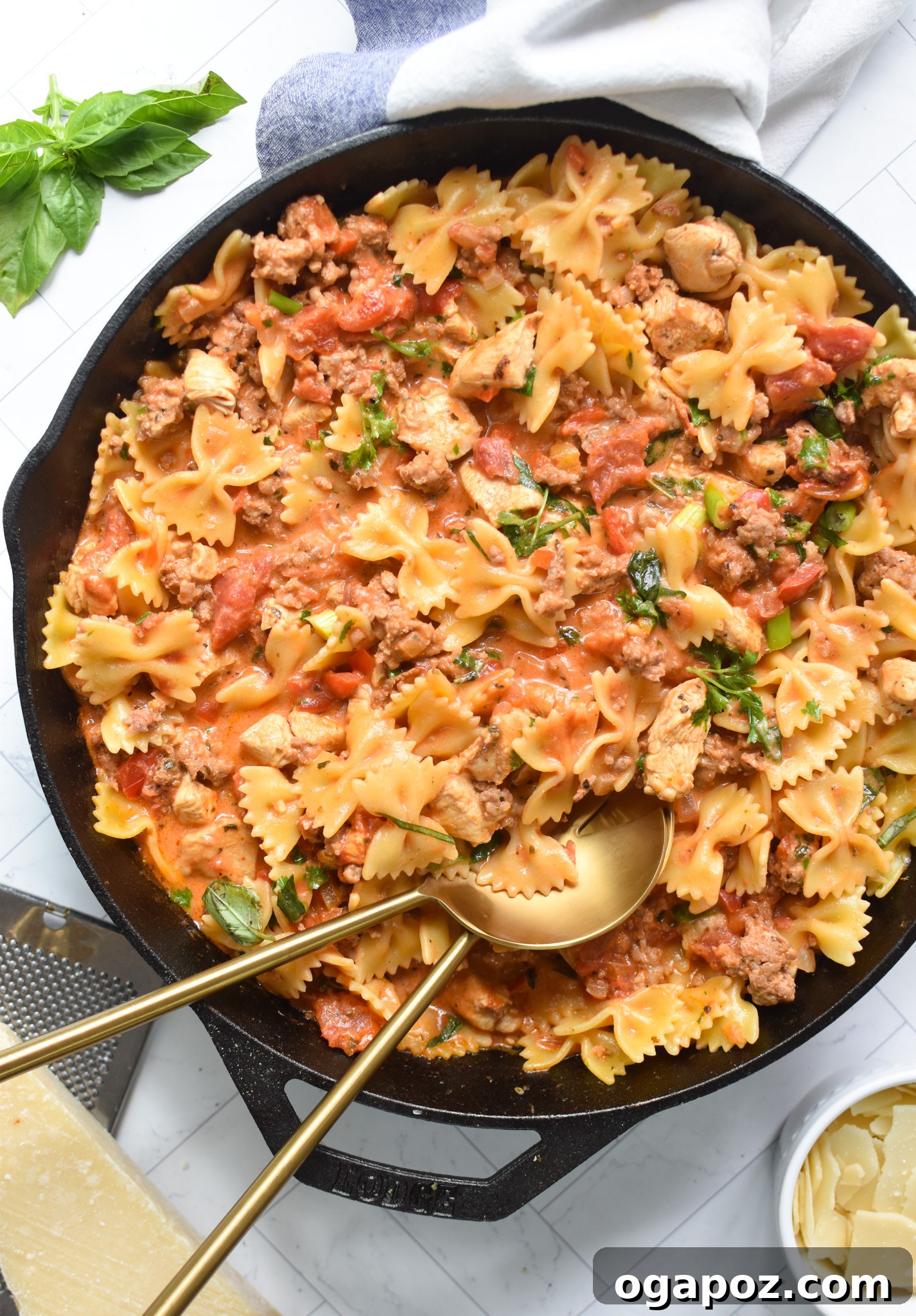 Irresistible Creamy Chicken Chorizo Pasta 8 A serving of Creamy Chicken and Chorizo Pasta, garnished with fresh herbs and served with gold spoons.