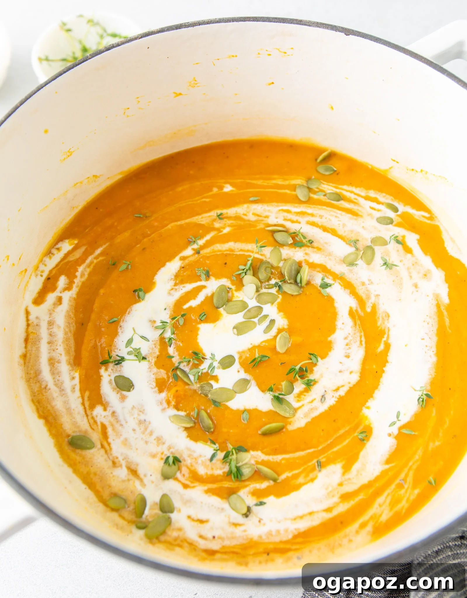 Creamy Roasted Butternut Squash Soup 11 A bowl of Easy Roasted Butternut Squash Soup garnished with Greek yogurt and fresh thyme.