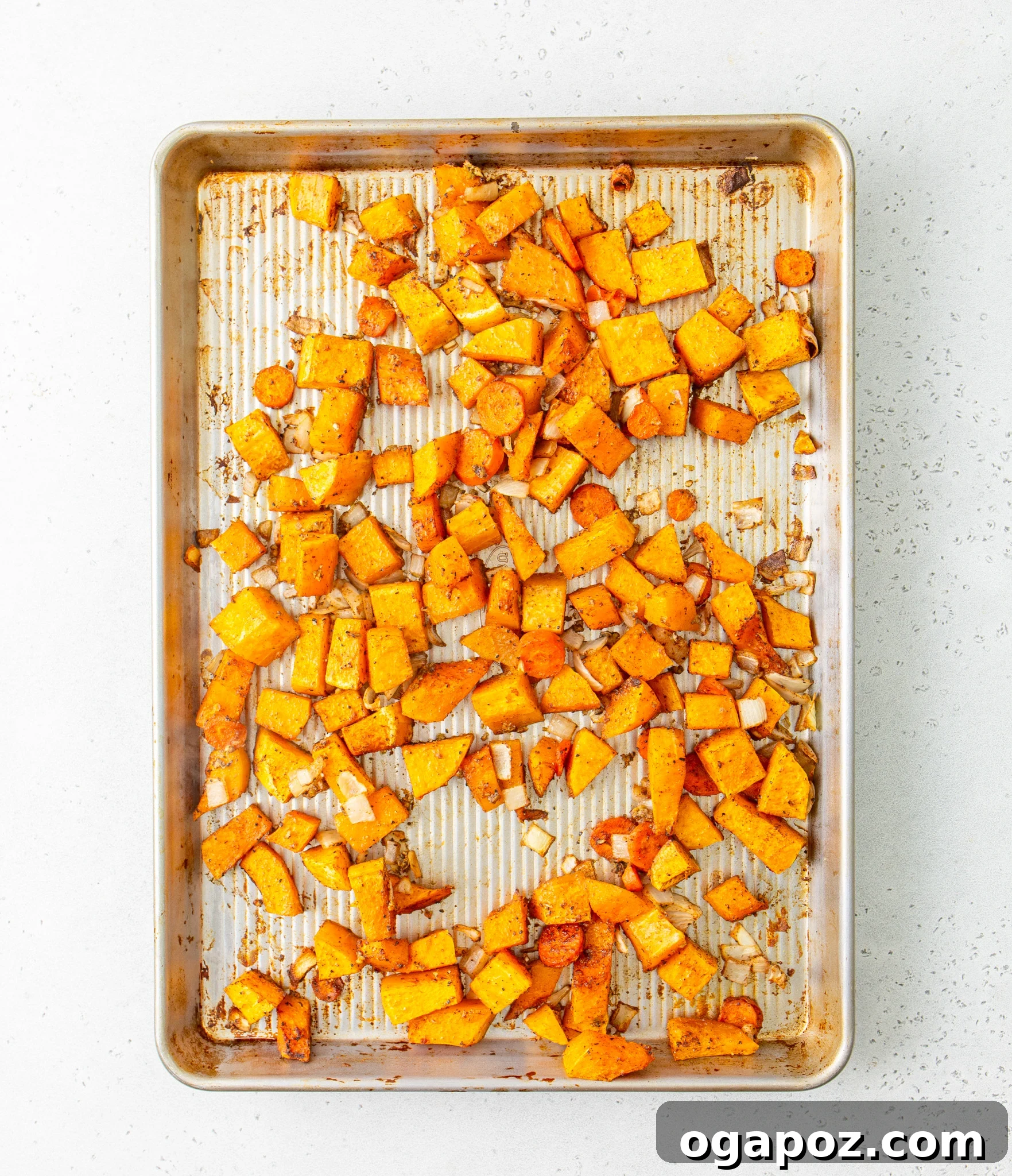 Creamy Roasted Butternut Squash Soup 9 Easy Roasted Butternut Squash Soup ingredients roasting on a baking tray in the oven.