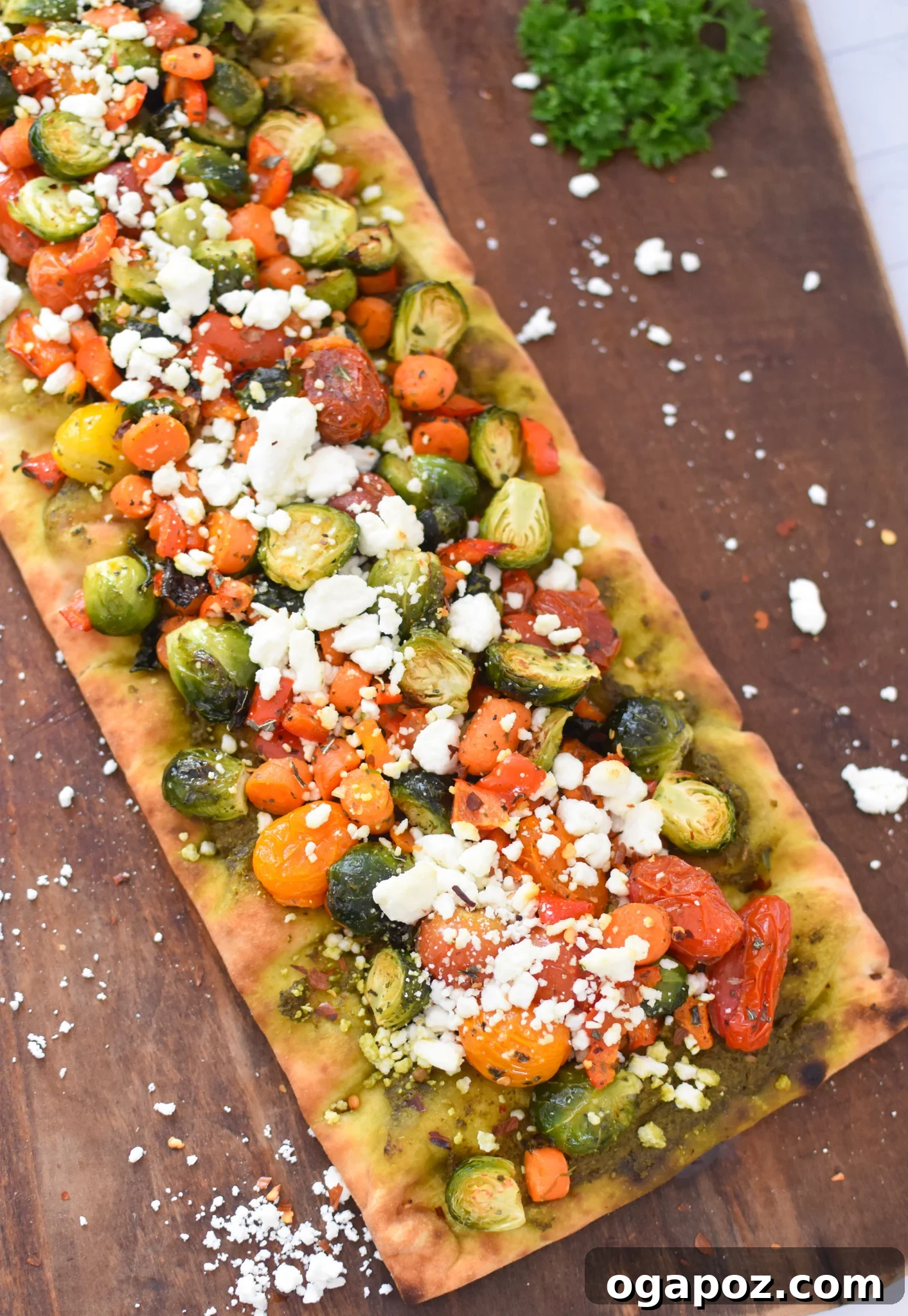 Gourmet Goat Cheese and Roasted Vegetable Flatbread 11 Assembled flatbreads topped with roasted vegetables and crumbled goat cheese, ready for the oven.