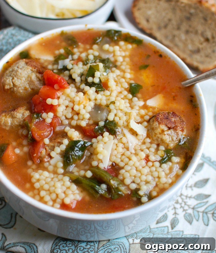 Nonna's Italian Wedding Soup 5 A top-down view of a comforting bowl of Italian Wedding Soup with fresh basil garnish.