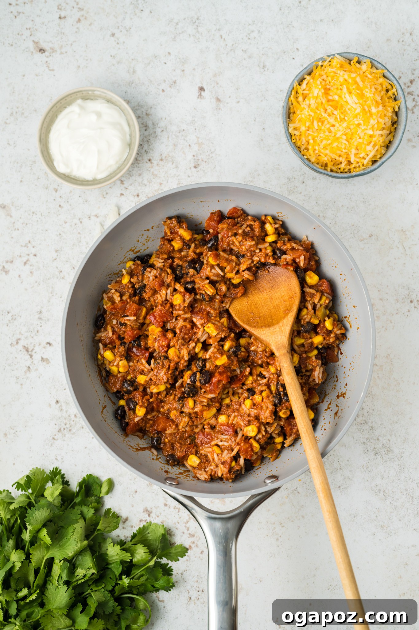 Cheesy Stuffed Poblano Peppers 7 The chorizo and vegetable filling mixture simmering in a skillet, showcasing the vibrant colors of tomatoes, corn, and beans.