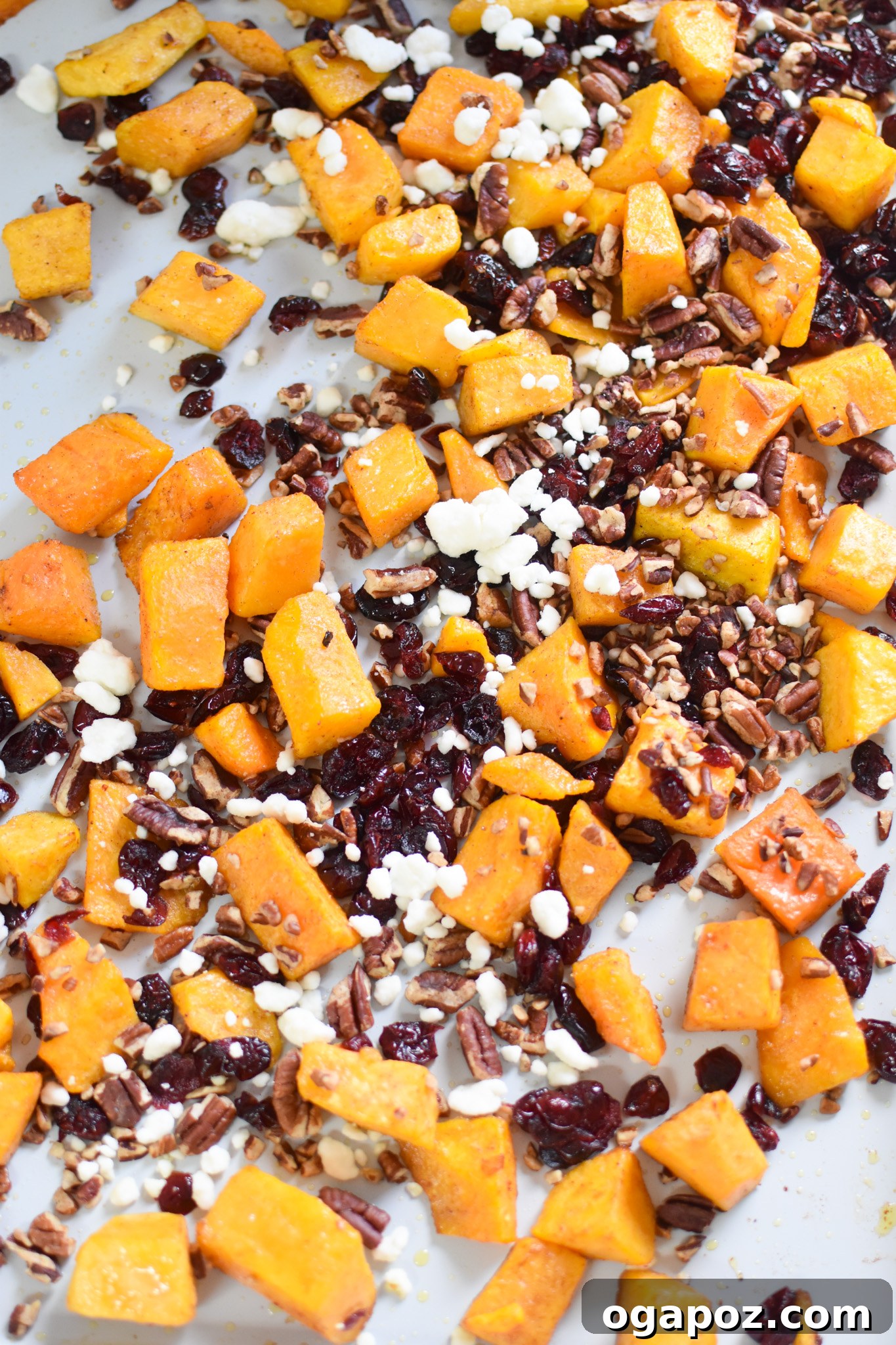 Butternut squash cubes spread evenly on a baking tray, ready for roasting.