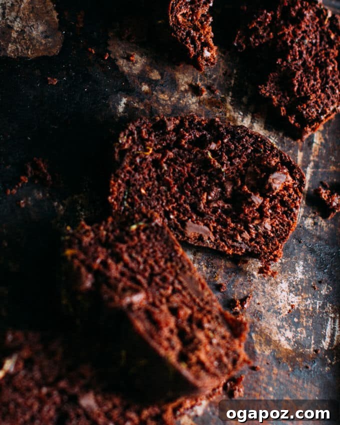 Hidden Veggie Chocolate Bread 6 A whole loaf of chocolate zucchini bread perfectly baked, resting on a clean white platter, hinting at its inviting aroma and texture.