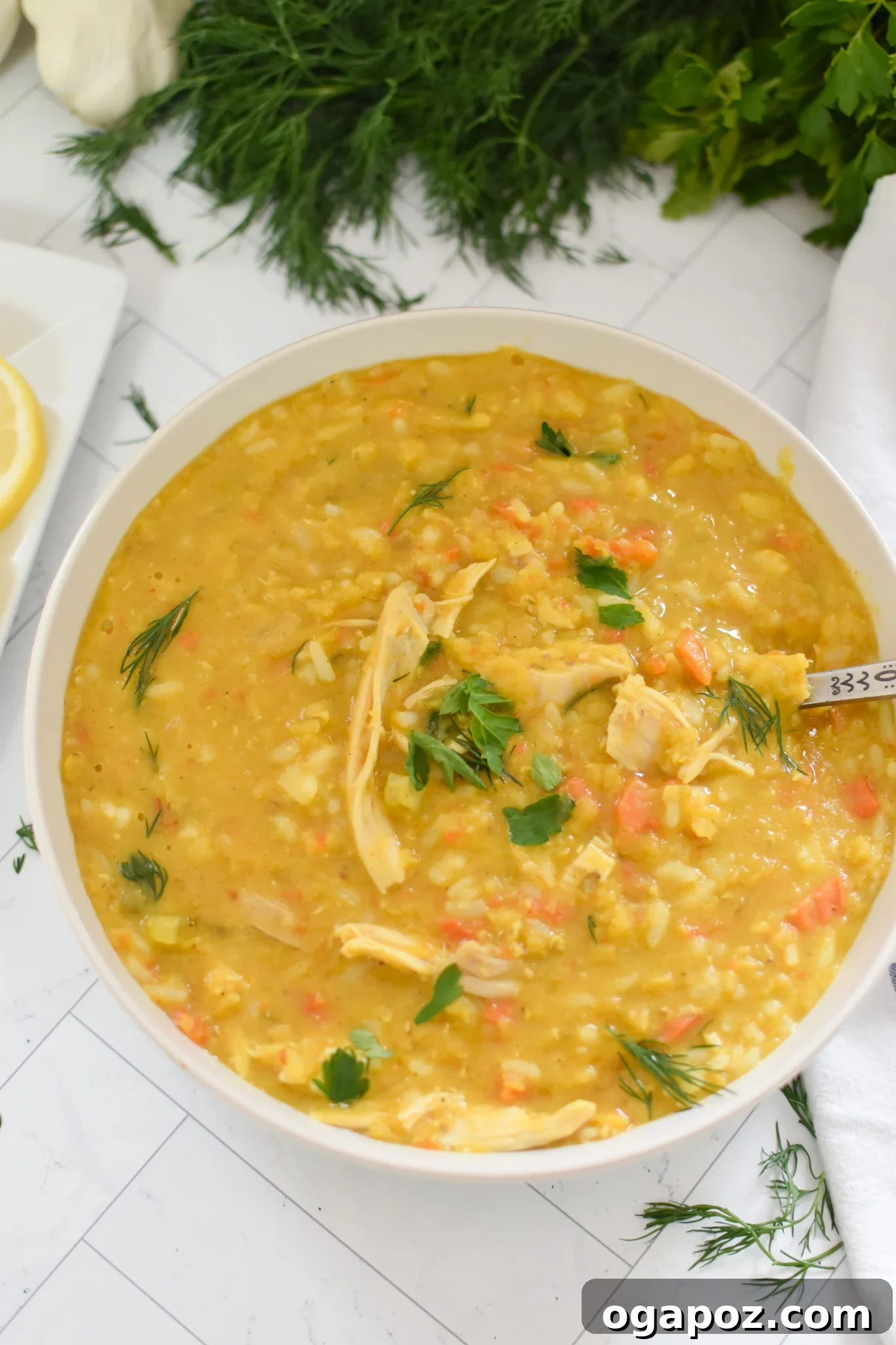 Hearty Chicken Lentil Soup 7 A spoon dipping into a bowl of richly textured Chicken Lentil Soup, inviting a taste.