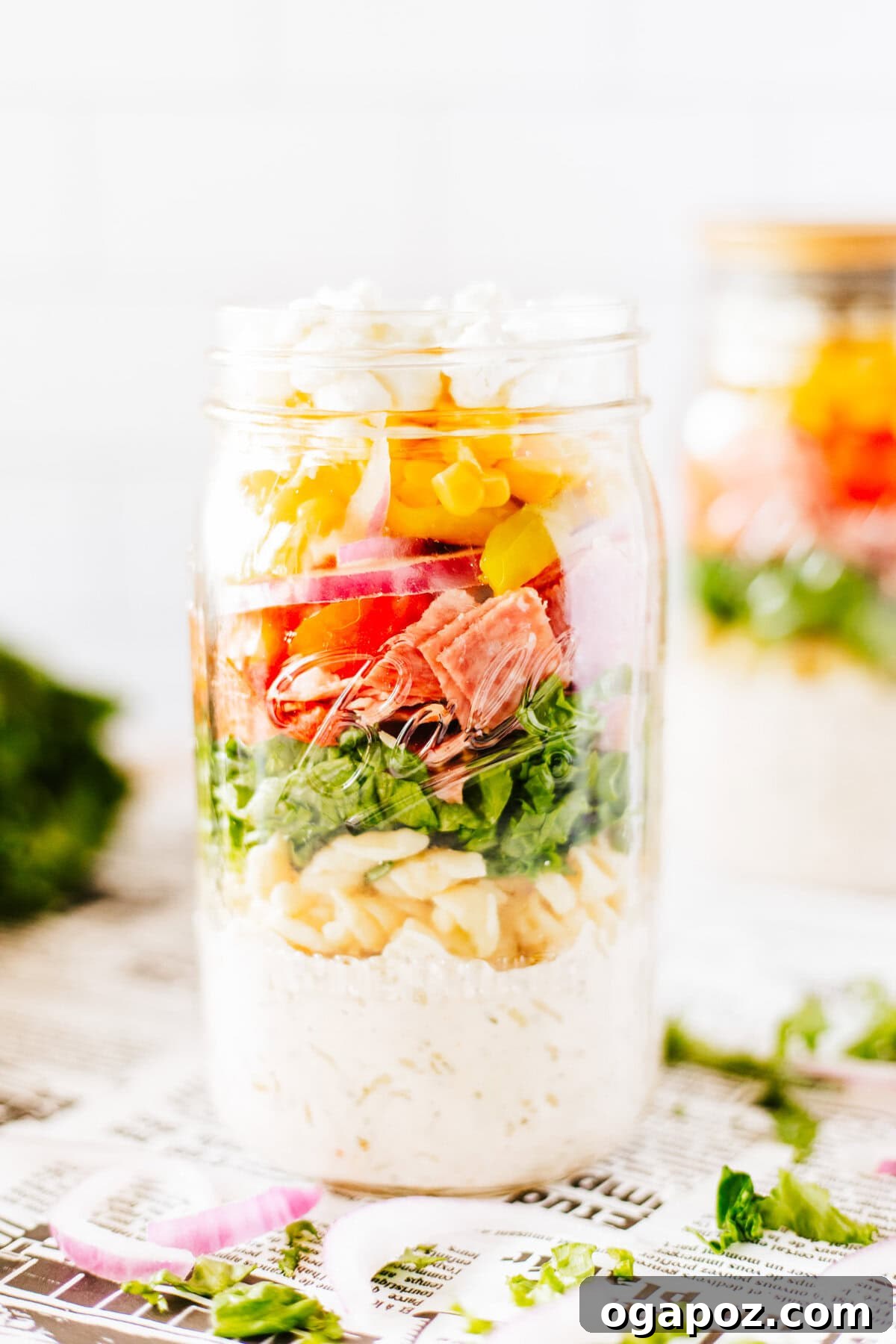 Portable Italian Pasta Salad Jars 3 A single Italian Pasta Mason Jar Salad, showcasing the distinct layers of ingredients.