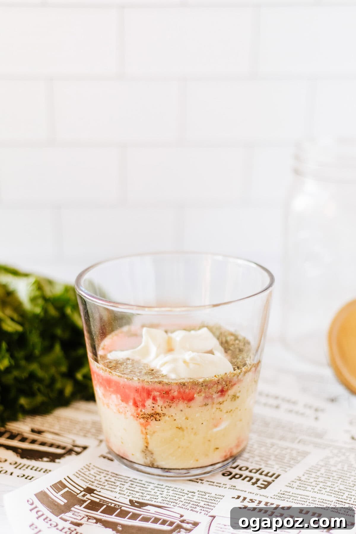Portable Italian Pasta Salad Jars 6 Creamy Italian dressing being poured into the bottom of a mason jar.