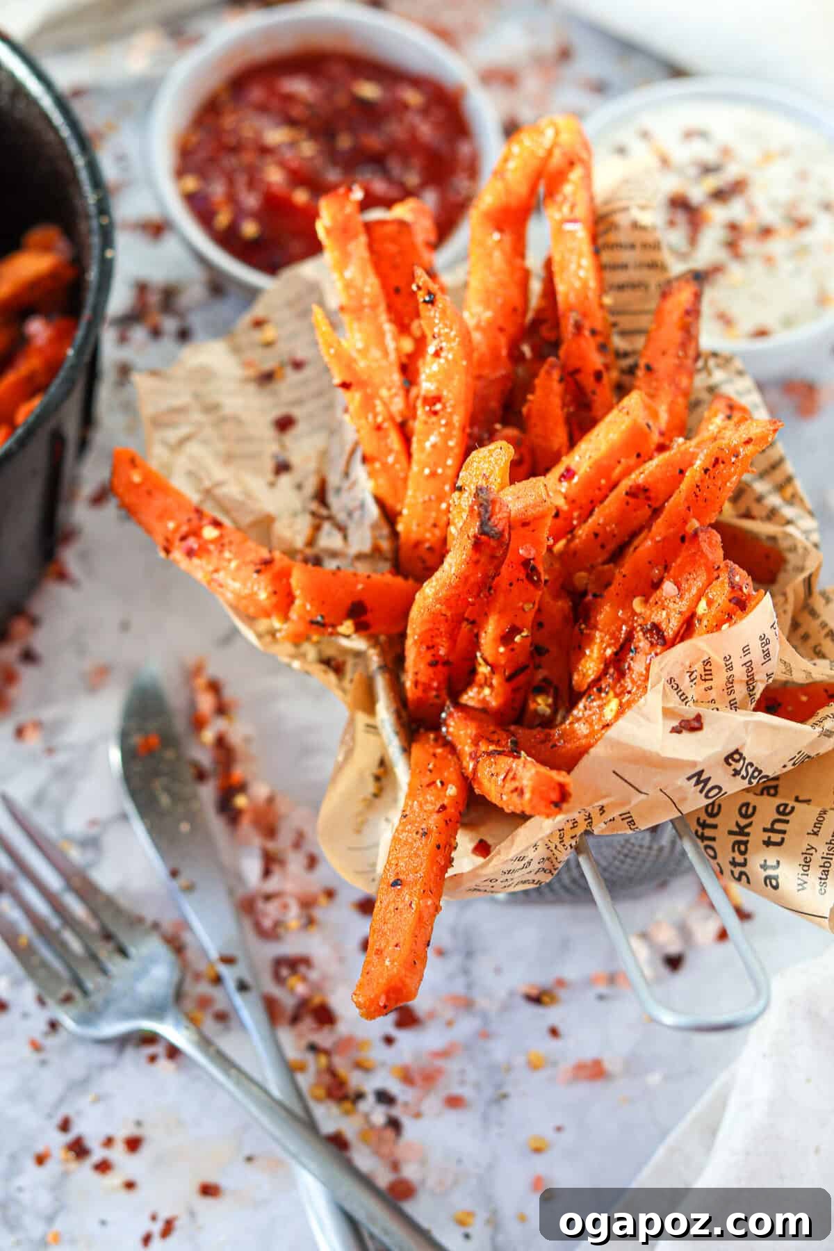 Crispy Air-Fried Sweet Potato Fries 4 Air Fryer Sweet Potato Fries served in a paper-lined cup, showing off their golden-brown color and crispy texture.