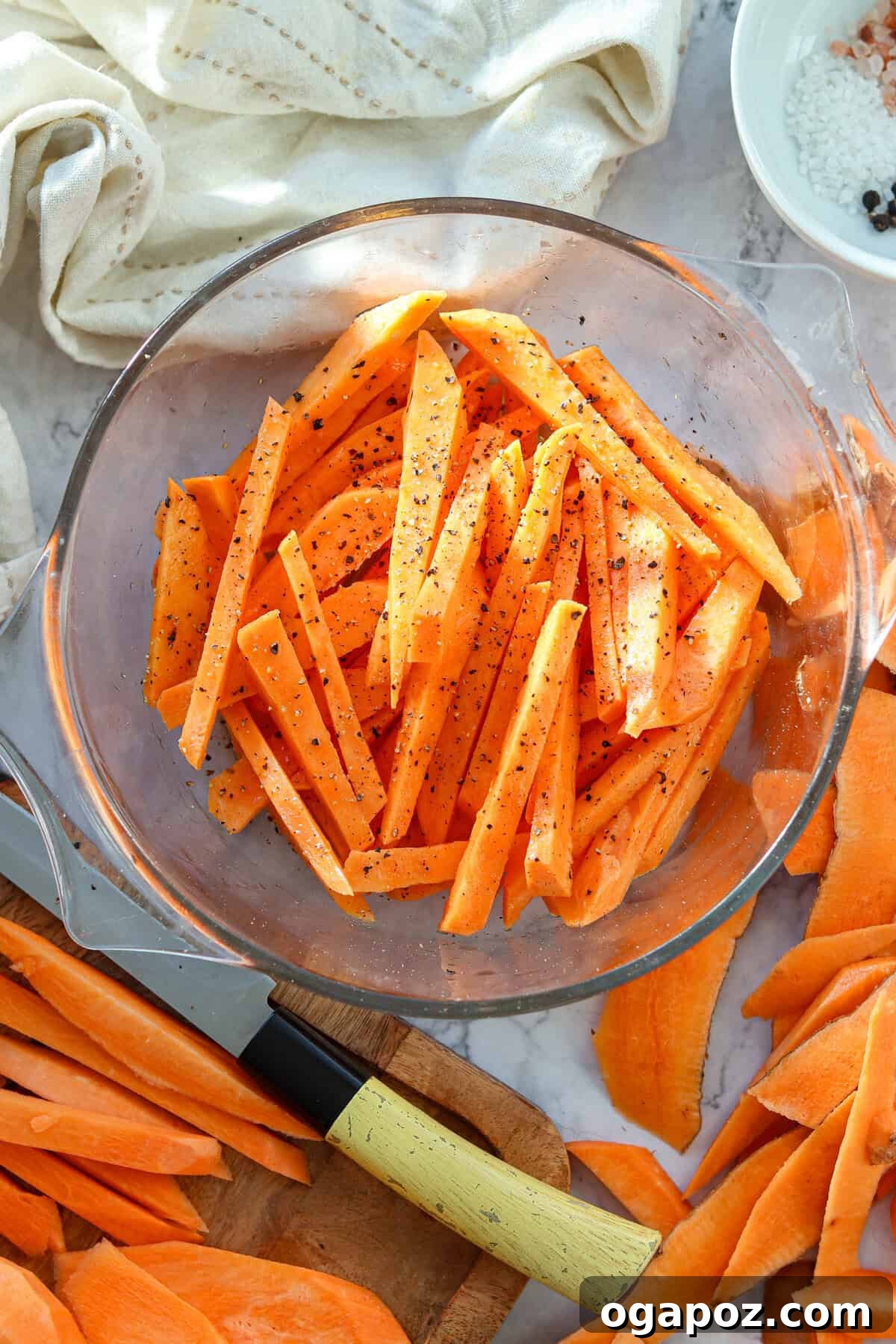 Crispy Air-Fried Sweet Potato Fries 6 Sweet potato fries in a bowl, coated with oil and chili flakes, salt, and pepper.