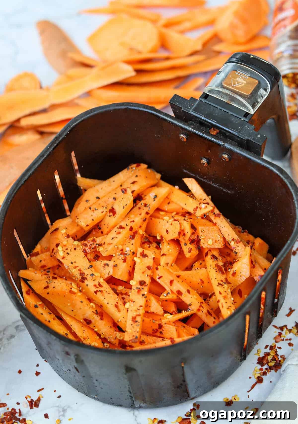Crispy Air-Fried Sweet Potato Fries 7 Crispy Air Fryer Sweet Potato Fries in the air fryer basket, freshly cooked and golden.
