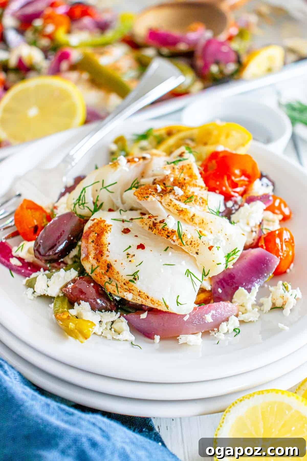 Sunny Mediterranean Cod Sheet Pan Bake 10 Sheet Pan Mediterranean Cod on a white bowl with fork
