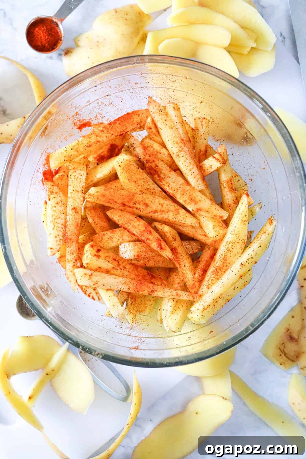 Crispy Air Fryer French Fries 7 Air Fryer French Fries Recipe with seasoning being mixed in a bowl