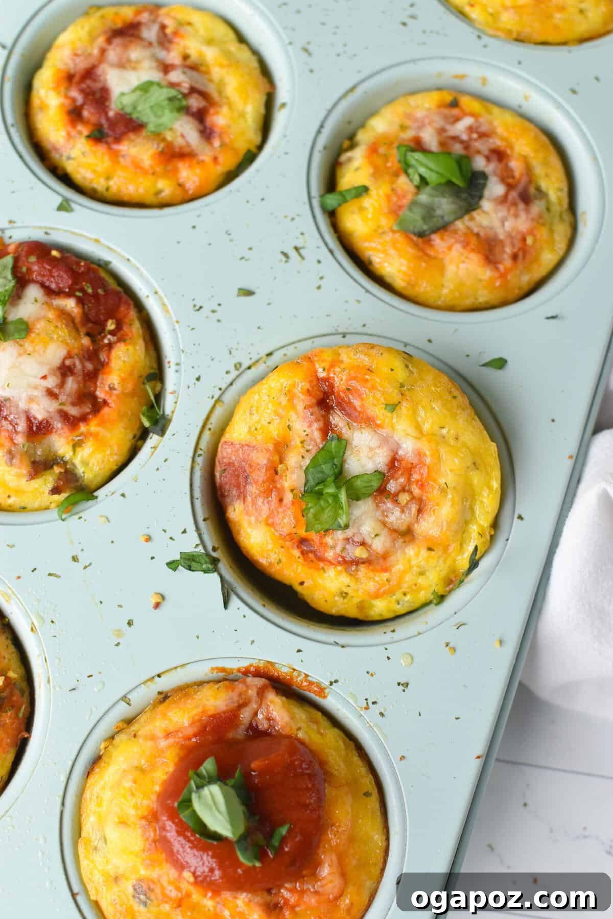Savory Pizza Egg Cups 2 Freshly baked Pizza Egg Muffins arranged neatly in a non-stick muffin tin, ready to be served or stored.