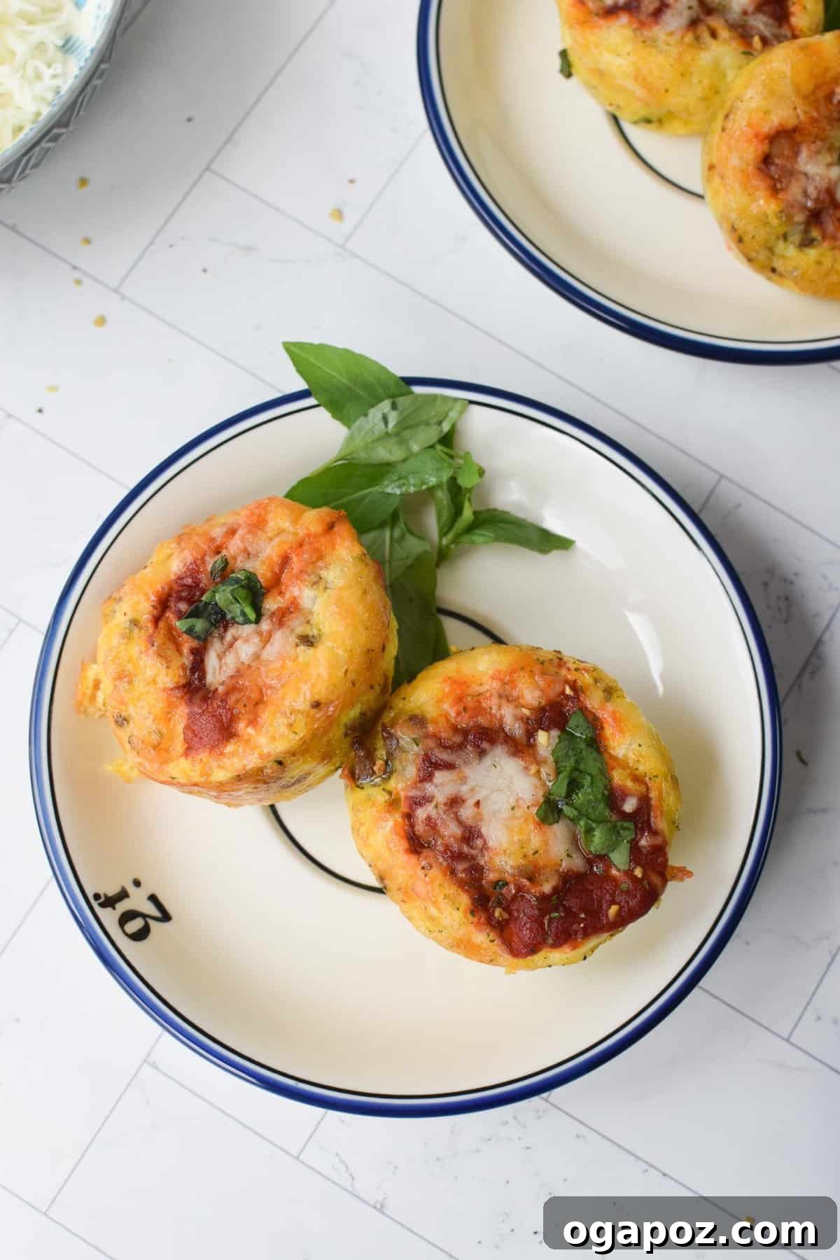 Savory Pizza Egg Cups 5 A delightful collection of freshly baked Pizza Egg Muffins presented on a rustic round plate, ready to be enjoyed.
