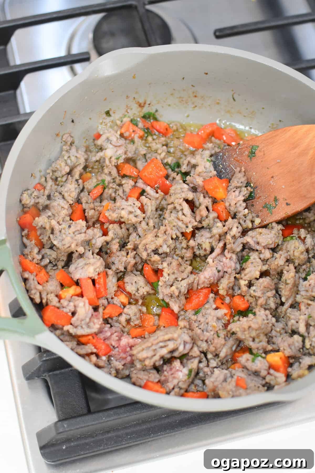 Savory Pizza Egg Cups 6 Ground sausage being cooked and seasoned in a skillet with spices, forming the savory base for Pizza Egg Muffins.