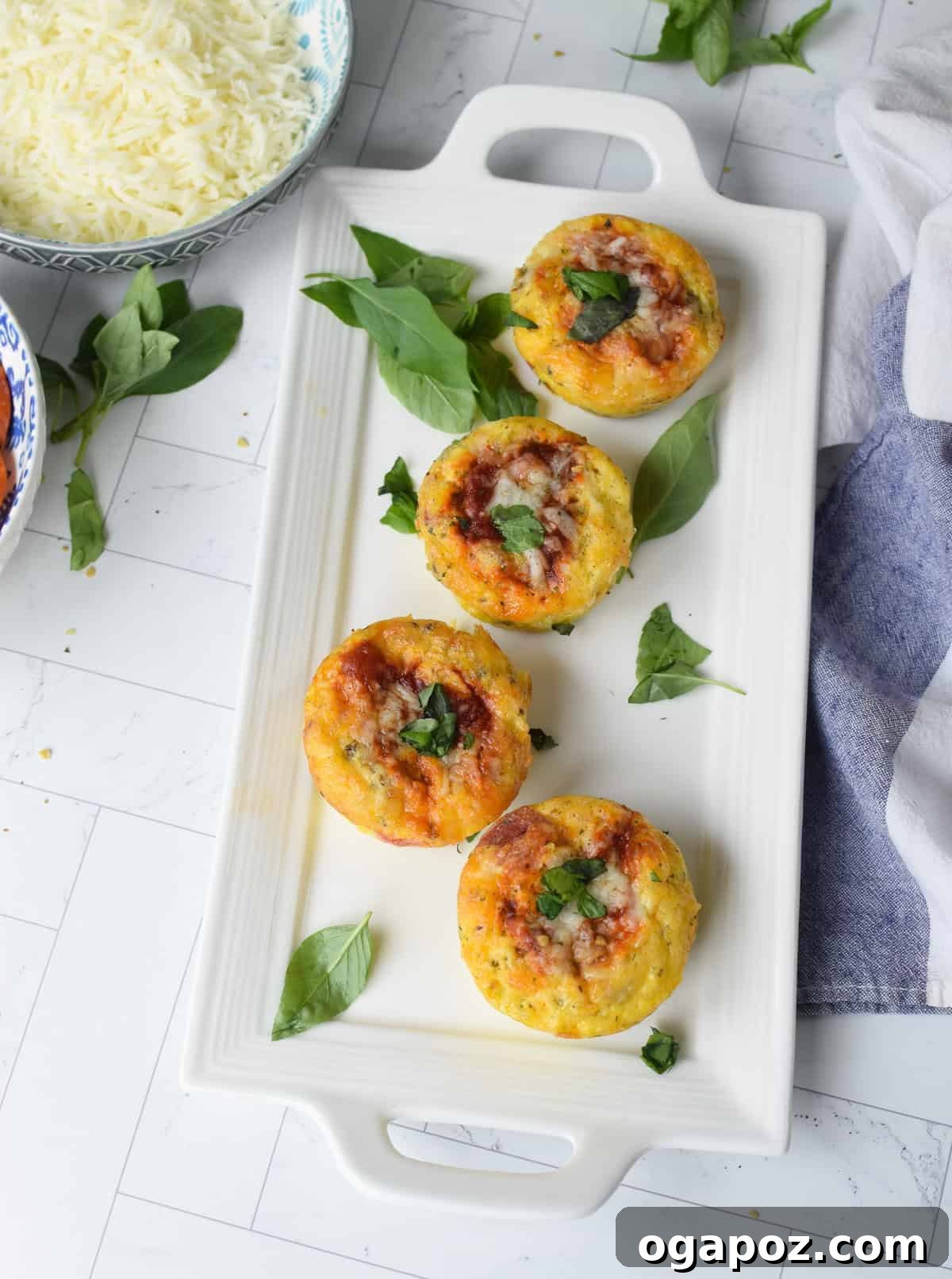Savory Pizza Egg Cups 10 A close-up view of a single, perfectly baked Pizza Egg Muffin on a pristine white plate, highlighting its fluffy texture and savory toppings.
