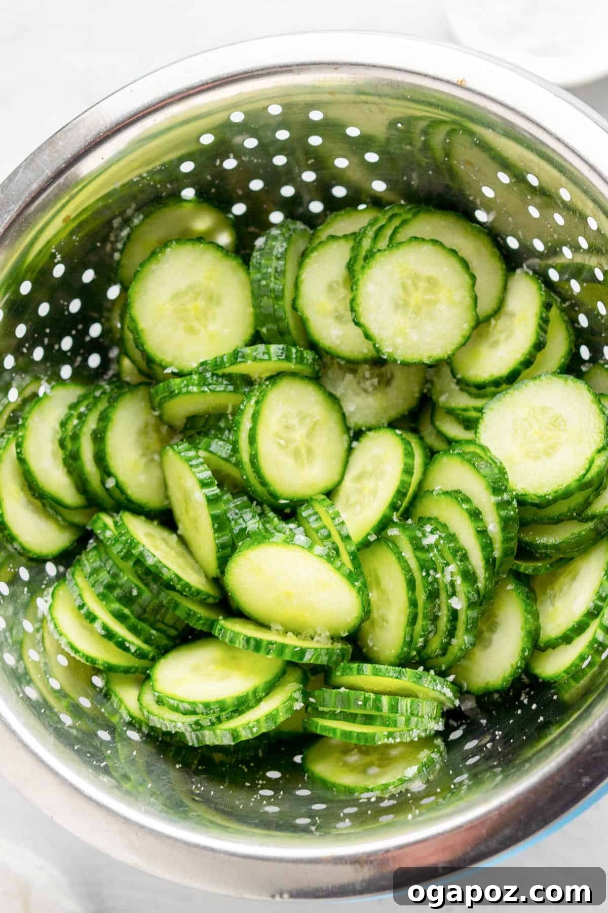 Cucumber Onion Salad cucumbers in a strainer