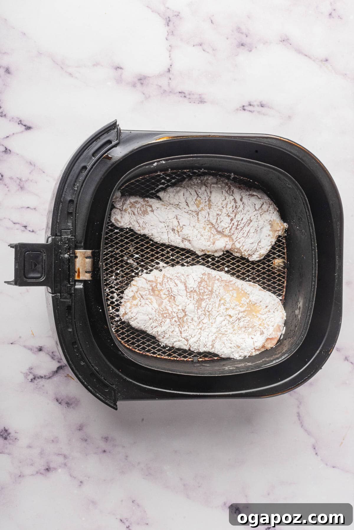 Ultimate Air Fryer Chicken Breast 8 Air Fryer Chicken Breast cooking in an air fryer basket