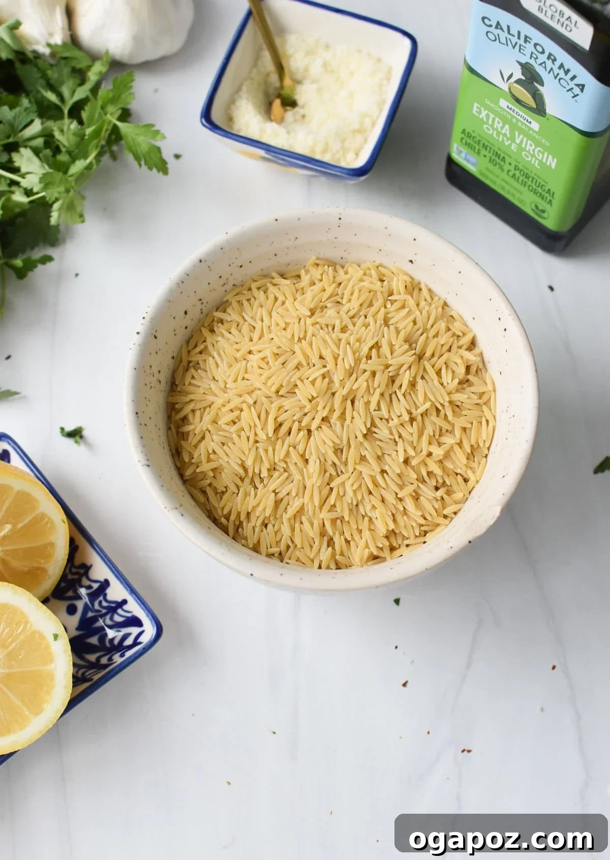 Bright Lemon Orzo Pasta 5 A selection of fresh ingredients for the Lemon Orzo Recipe, including lemons, garlic, and orzo pasta.