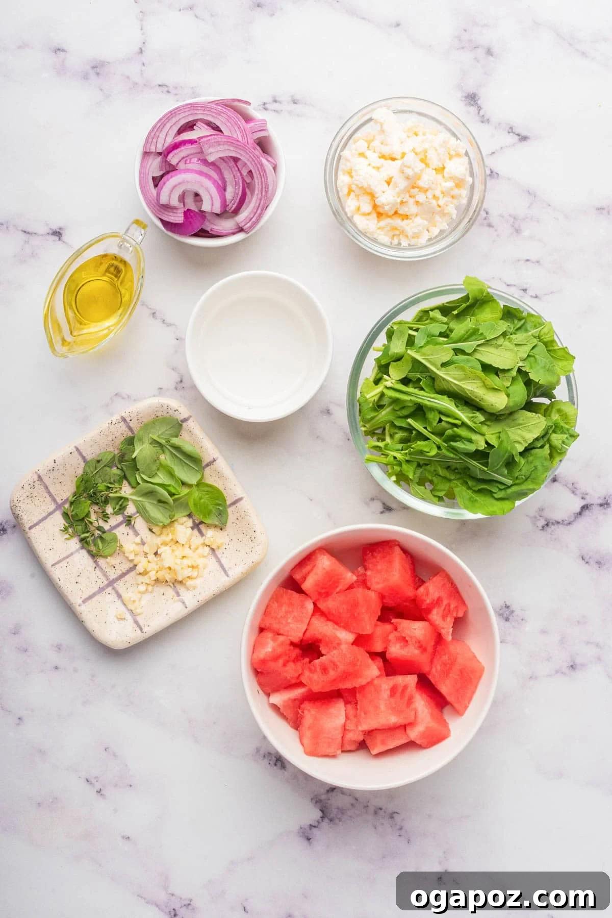 Watermelon Arugula Zing 4 Individual ingredients for Watermelon Arugula Salad laid out on a surface