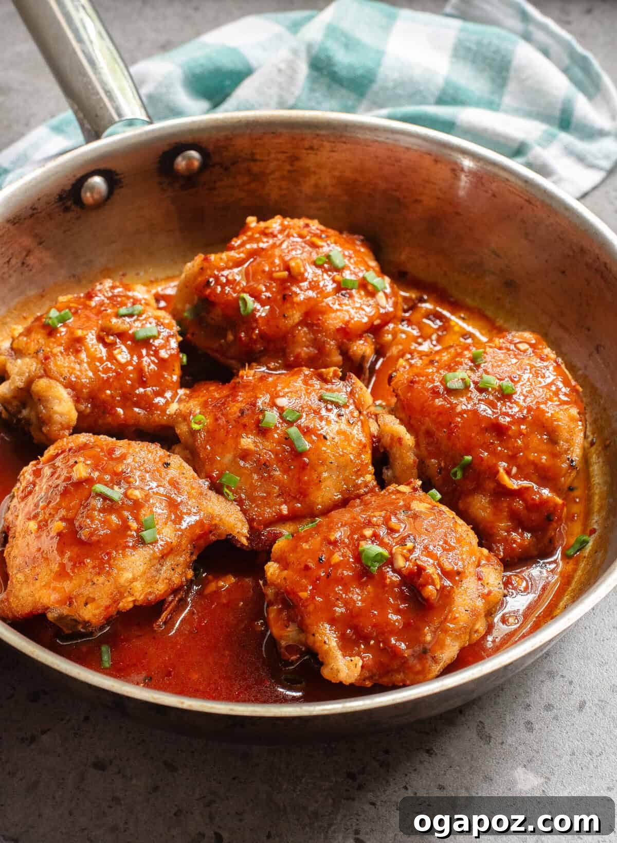 Sticky Honey Ginger Chicken 7 Honey Ginger Chicken simmering in a skillet with the glazed sauce.
