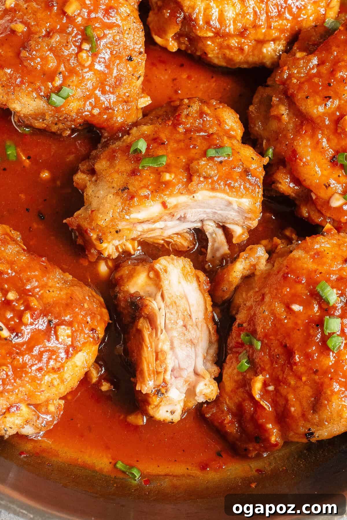 Sticky Honey Ginger Chicken 9 Perfectly cooked Honey Ginger Chicken thigh, sliced to show its tender interior.