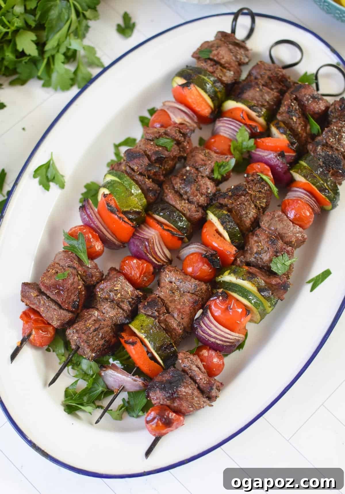 Grilled Beef Souvlaki Skewers 2 Perfectly grilled Beef Souvlaki on a white platter, ready to be served.
