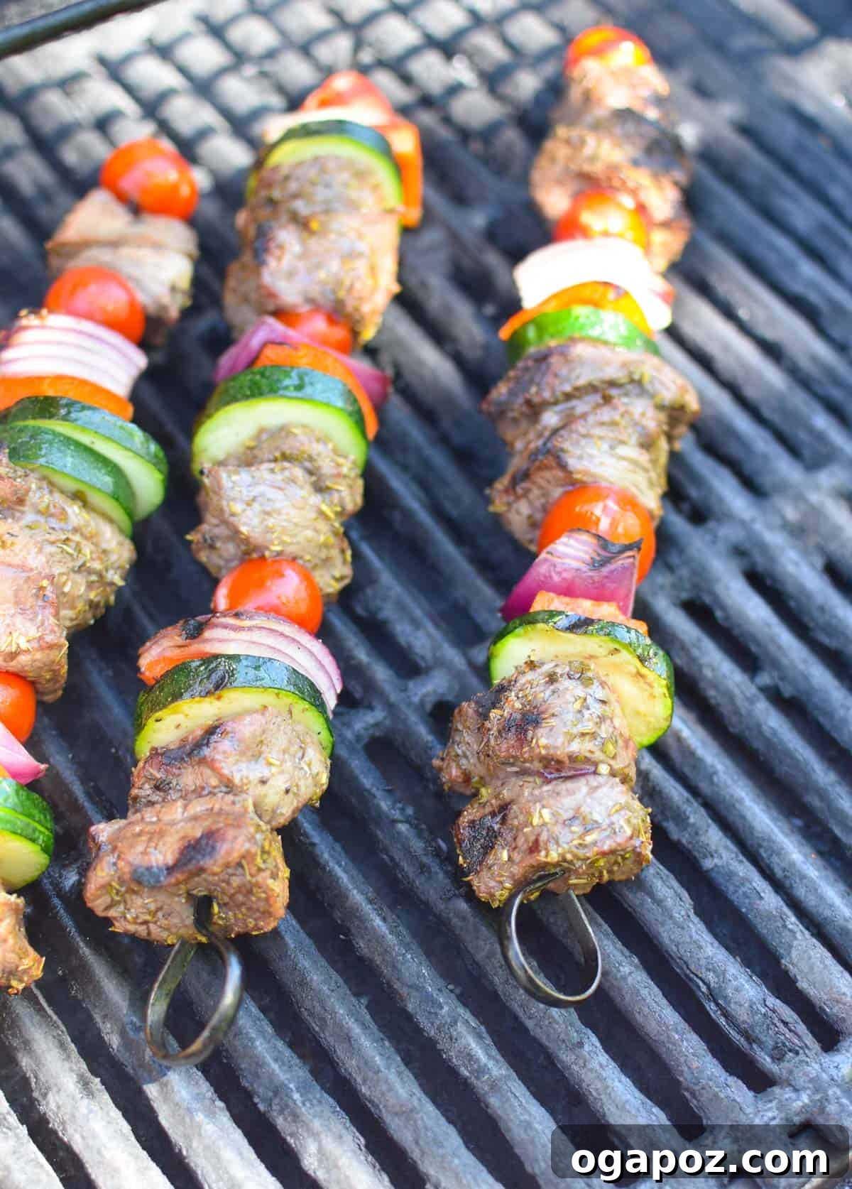 Grilled Beef Souvlaki Skewers 11 Beef Souvlaki skewers cooking on a hot grill, showing grill marks.