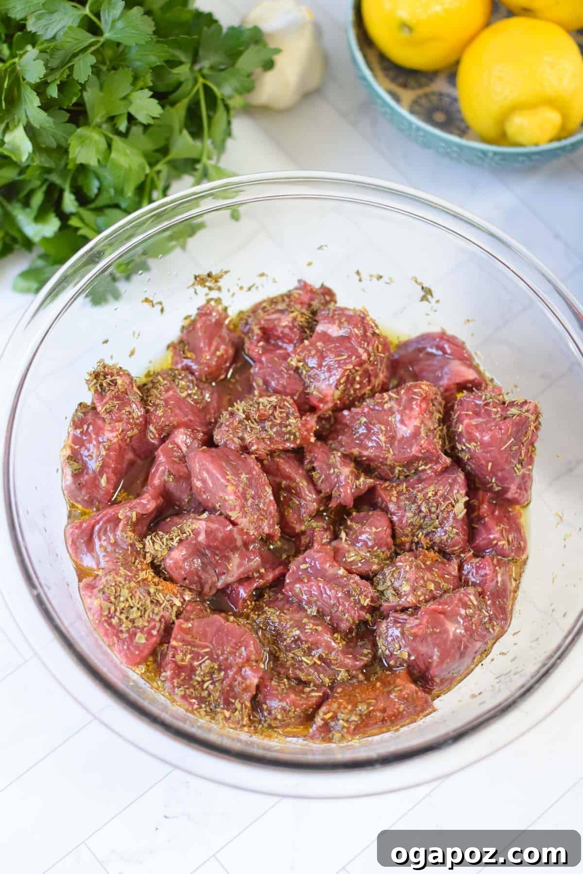 Grilled Beef Souvlaki Skewers 5 Beef Souvlaki beef cubes marinating in a bowl.