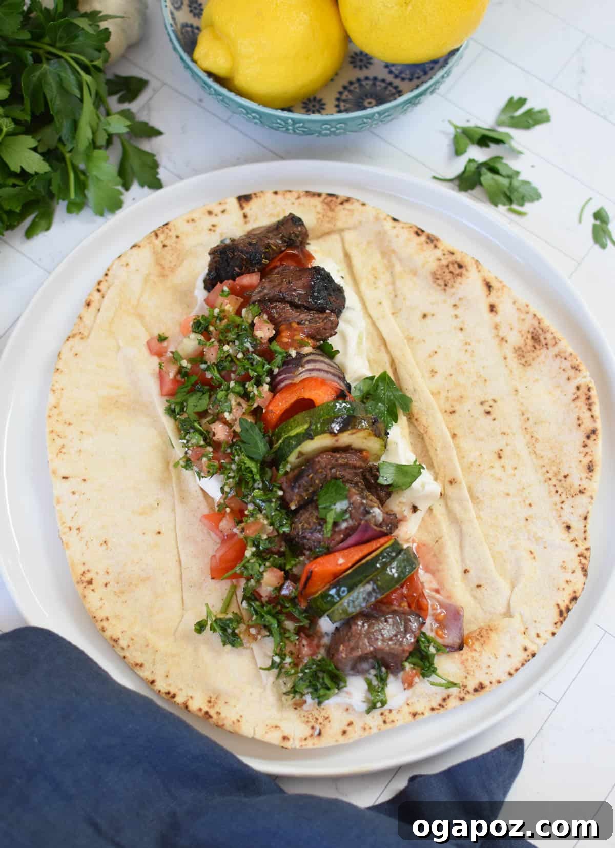 Grilled Beef Souvlaki Skewers 7 Beef Souvlaki served in a warm pita bread with tzatziki and vegetables.