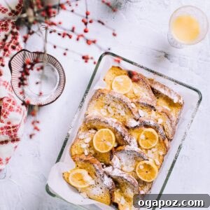 Baked Christmas Morning French Toast Casserole in pan, garnished with powdered sugar.