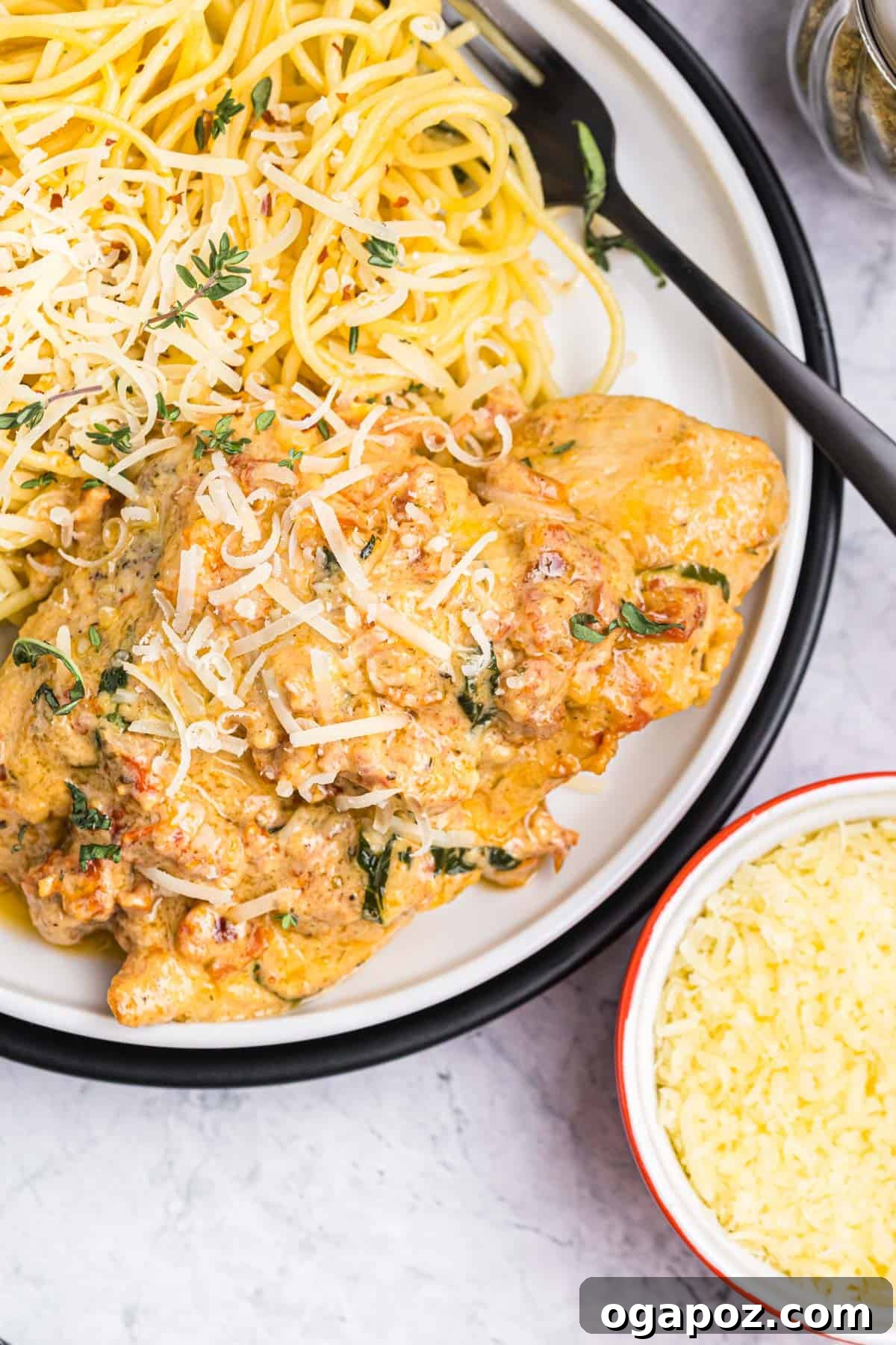 Proposal Perfect Chicken 2 A delicious plate of Marry Me Chicken, featuring golden-brown chicken breasts in a rich, creamy sauce with sun-dried tomatoes and fresh herbs.