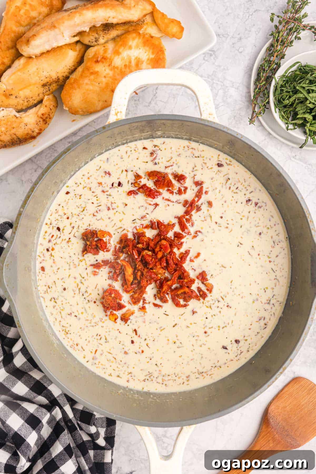 Proposal Perfect Chicken 10 The creamy sun-dried tomato sauce simmering in the skillet.