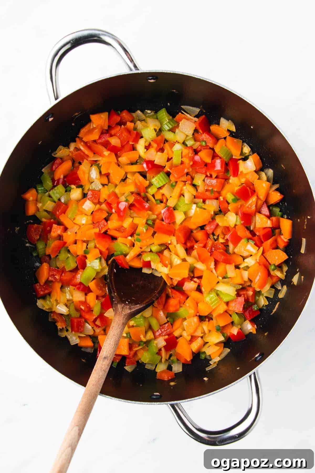 Flavorful Mexican Lentil Stew 8 Mexican Lentil Soup ingredients simmering in a skillet, including spices and vegetables.