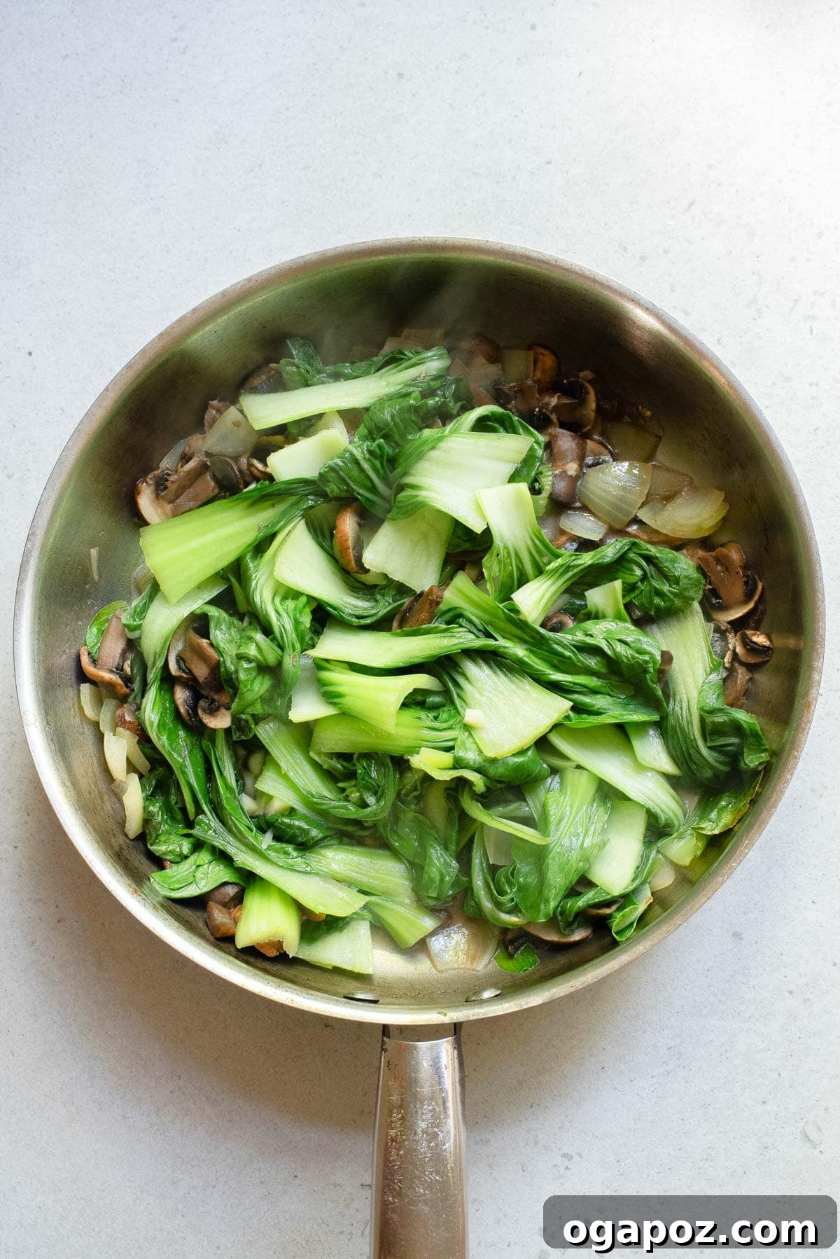 Vibrant Garlic Bok Choy Sauté 8 Bok Choy Stir Fry being stirred in a pan, showing the rich color of the soy sauce.