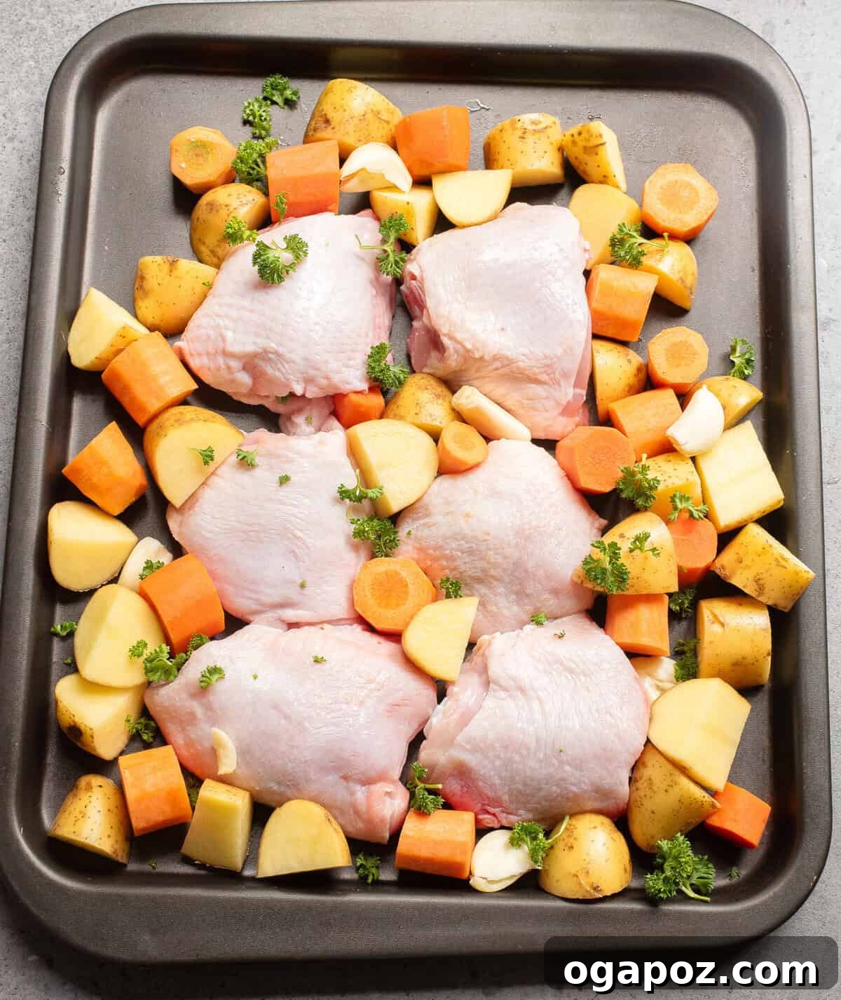 Golden Honey Mustard Sheet Pan Chicken Thighs 6 Sheet Pan Honey Mustard Chicken Thighs raw chicken on a baking sheet with chopped vegetables