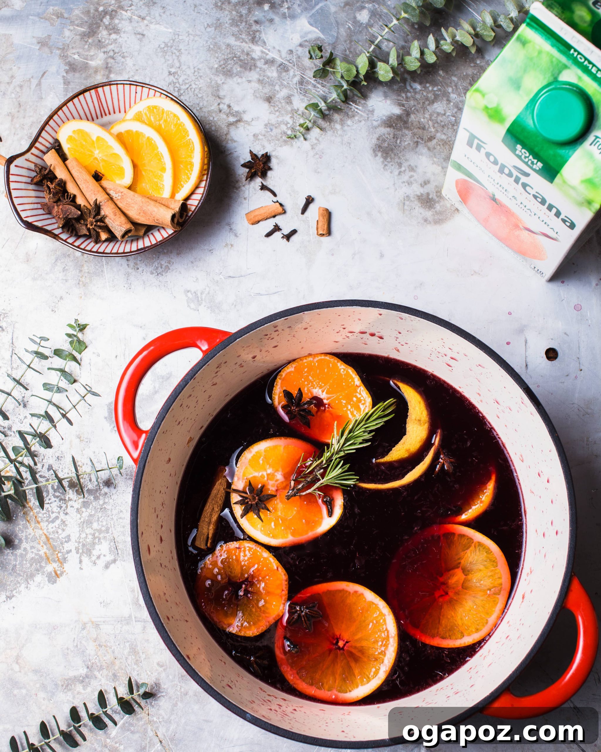 Zesty Winter Warmer 4 Mulled Wine in glasses garnished with orange slices and rosemary