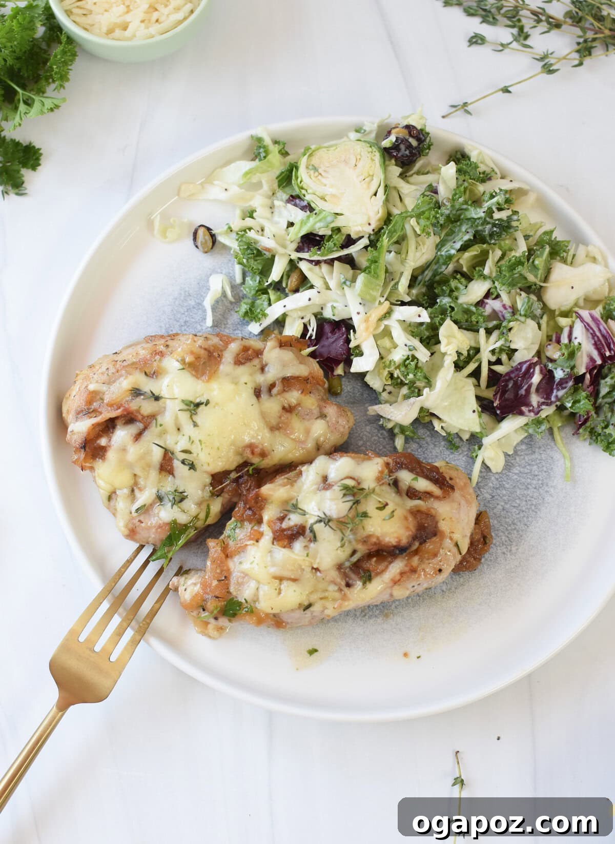 French Onion Pork Chops served elegantly with a fresh side salad in the background.