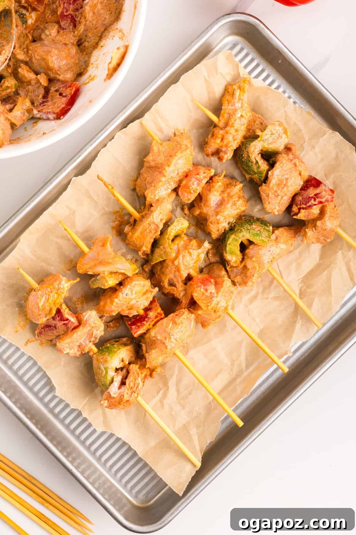 Zesty Grilled Chicken Tikka Skewers 9 Chicken and bell peppers meticulously threaded onto skewers, ready for cooking