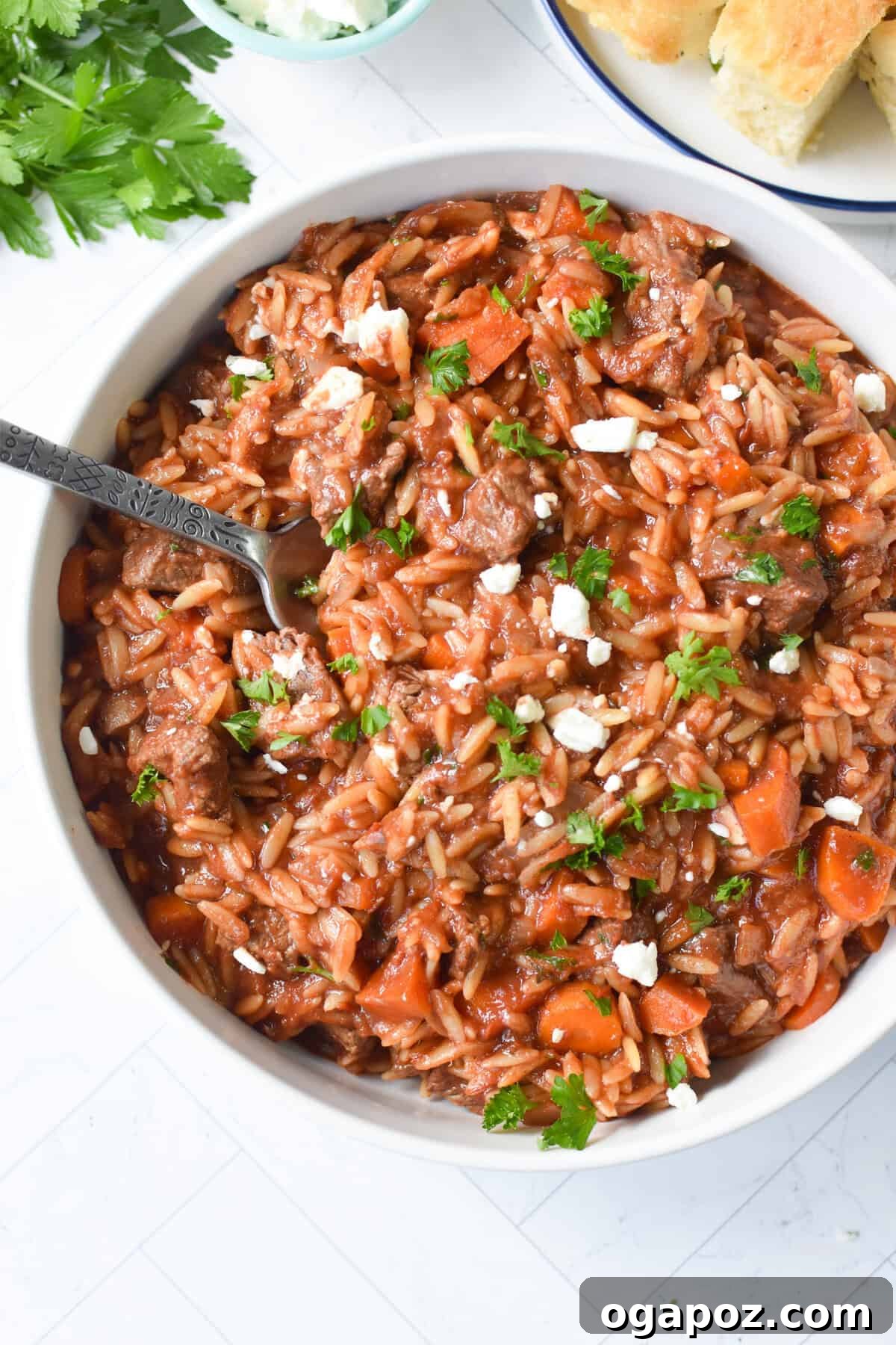 Hearty Greek Giouvetsi Beef Orzo Stew 2 Greek Beef Stew with Orzo served in a bowl with a spoon