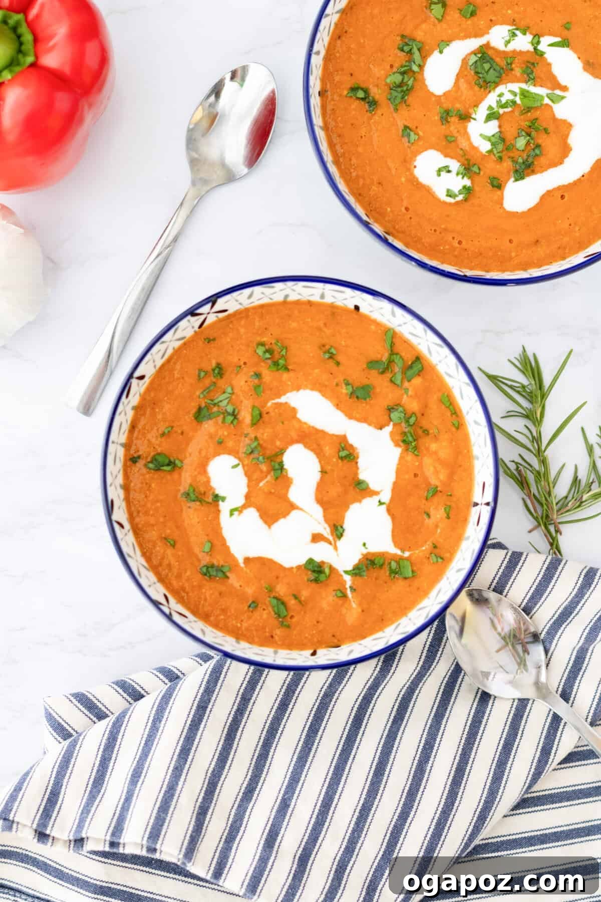 Comforting Lentil Tomato Soup 3 Two bowls of Lentil Tomato Soup, one white and one blue, showcasing the vibrant color and texture.
