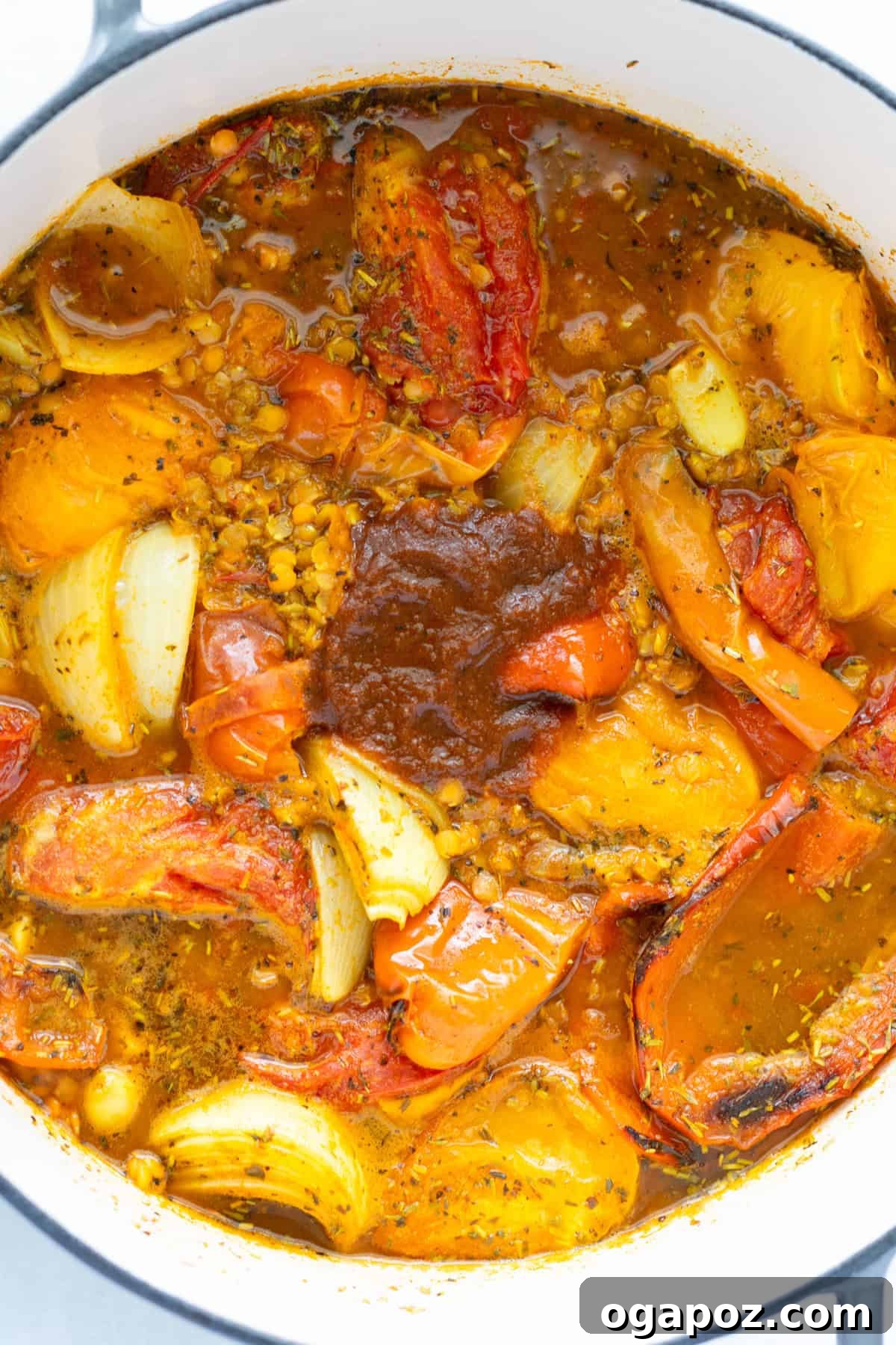Comforting Lentil Tomato Soup 9 Lentil Tomato Soup ingredients simmering in a Dutch oven on the stove.
