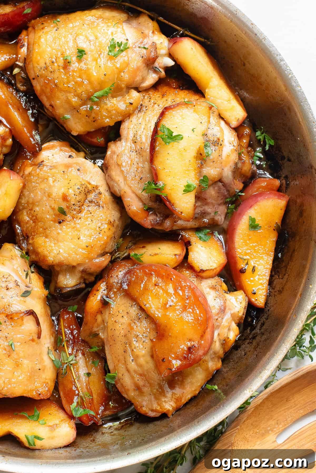 Cider-Glazed Skillet Chicken 2 Skillet Apple Cider Chicken in a cast iron skillet with fresh thyme garnish