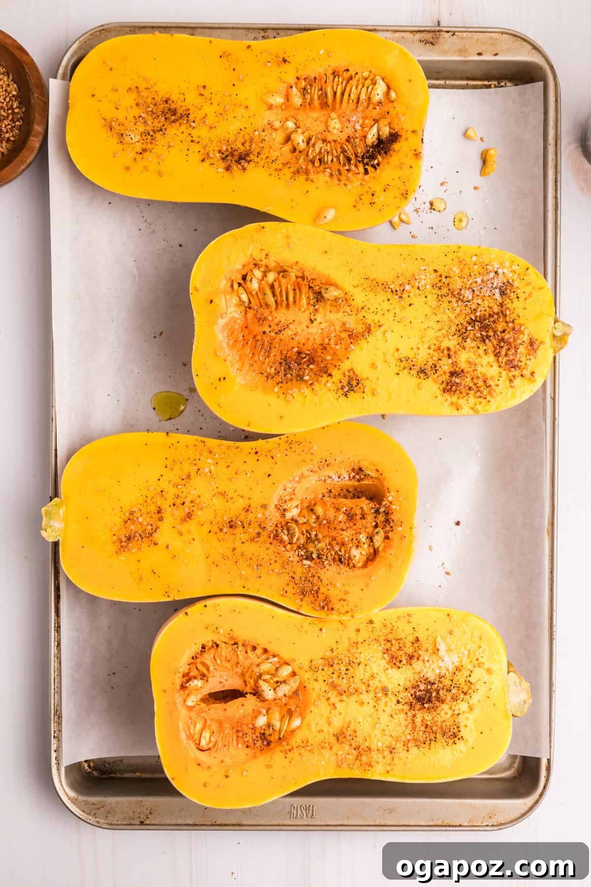 Flavorful Mediterranean Stuffed Butternut Squash Boats 8 Butternut squash halves, cut open and seasoned on a baking sheet, ready for roasting