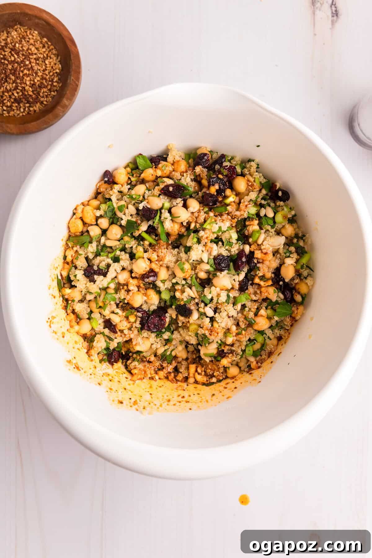 Flavorful Mediterranean Stuffed Butternut Squash Boats 9 A large bowl containing the vibrant quinoa stuffing mixture with cranberries, pine nuts, and herbs